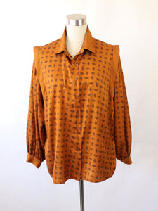 Reetriikka Tammi-tuote tiilenoranssi kuviollinen 80-luvun vintagepusero 48